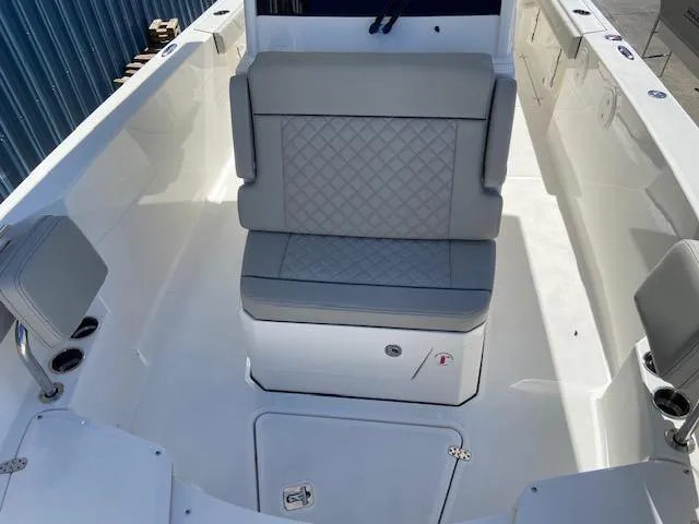 Slide: The Image of 2024 Pursuit S 268 boat interior with cushioned seating and storage. - 21