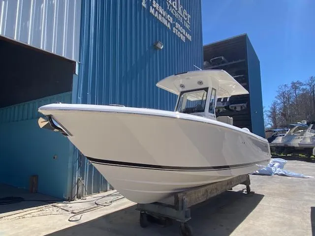 Slide: The Image of 2024 Pursuit S 268 boat outside a blue storage facility. - 3