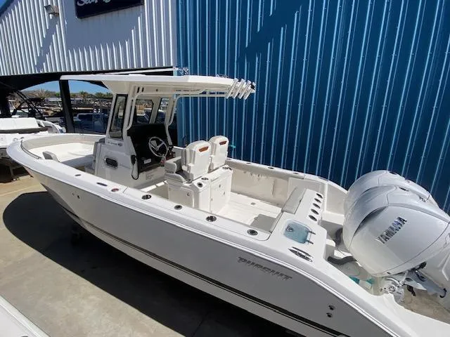 Slide: The Image of 2024 Pursuit S 268 boat with dual Yamaha engines docked at a marina. - 9