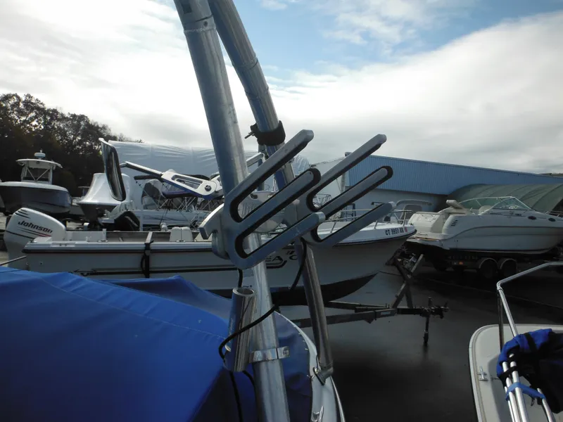 Slide: The Image of 2006 Larson SEi 180 Sport I/O boat in a marina with other boats. - 15