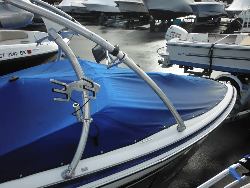Slide: The Image of 2006 Larson SEi 180 Sport I/O boat with blue cover in storage. - 19