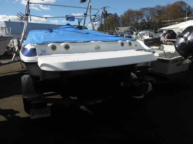 Slide: The Image of 2006 Larson SEi 180 Sport I/O boat with blue cover, parked on a trailer. - 20