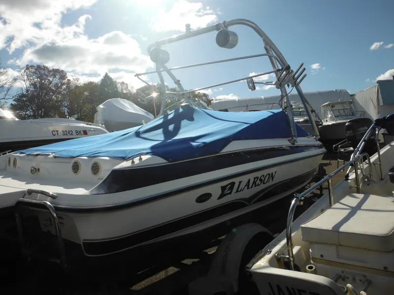 Slide: The Image of 2006 Larson SEi 180 Sport I/O boat with blue cover in storage. - 24