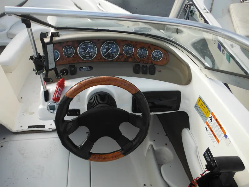 Slide: The Image of 2006 Larson SEi 180 Sport I/O boat dashboard with steering wheel and instrument panel. - 26
