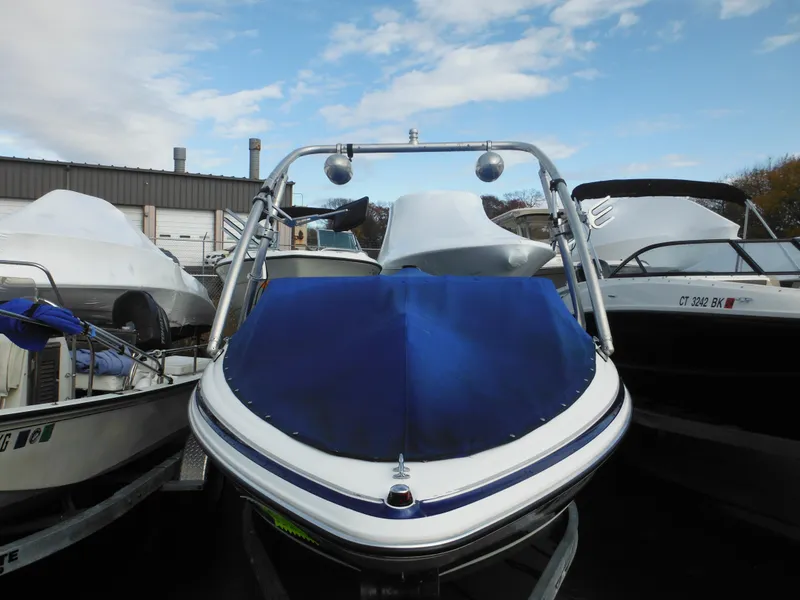 Slide: The Image of 2006 Larson SEi 180 Sport I/O boat with blue cover in storage. - 3