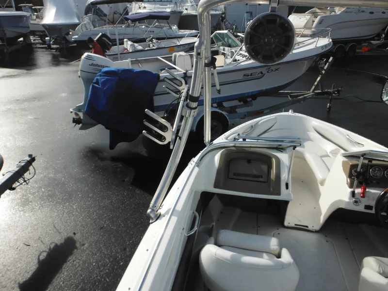 Slide: The Image of 2006 Larson SEi 180 Sport I/O boat in a marina with other boats. - 37