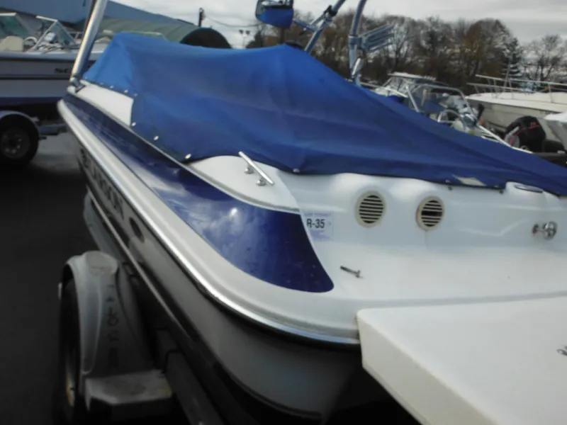 Slide: The Image of 2006 Larson SEi 180 Sport I/O boat with blue cover on trailer. - 7