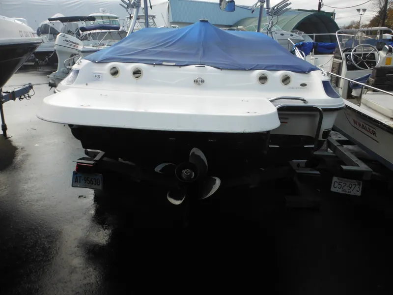 Slide: The Image of 2006 Larson SEi 180 Sport I/O boat with blue cover, docked at marina. - 9