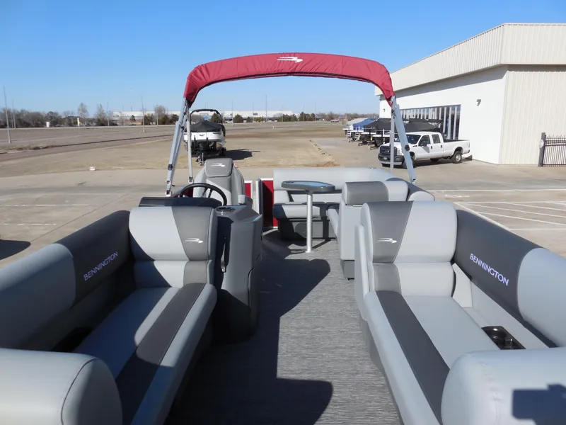 Slide: The Image of 2024 Bennington 188 SVL pontoon boat with gray seating and red canopy. - 4