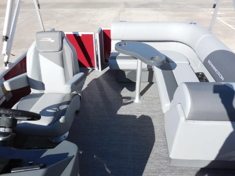 Slide: The Image of 2024 Bennington 188 SVL pontoon boat interior with gray seating and table. - 6