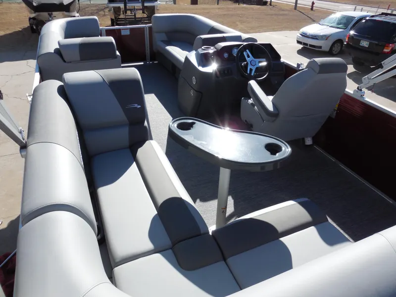Slide: The Image of 2024 Bennington 188 SVL pontoon boat interior with plush seating and captain's chair. - 8