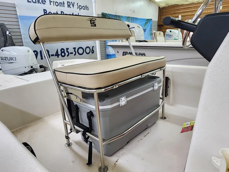 Slide: The Image of 2024 Carolina Skiff E18 JVX CC boat interior with bench seat and cooler. - 10