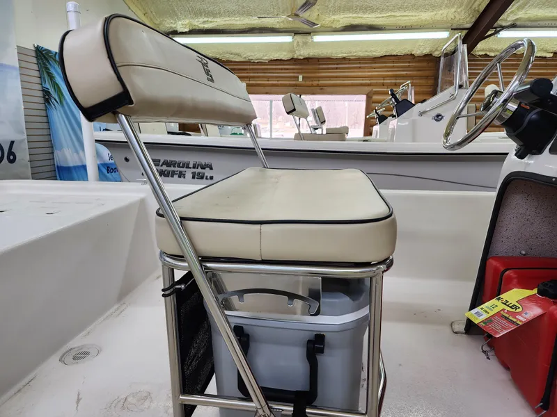 Slide: The Image of 2024 Carolina Skiff E18 JVX CC boat interior with cushioned seating and storage. - 11