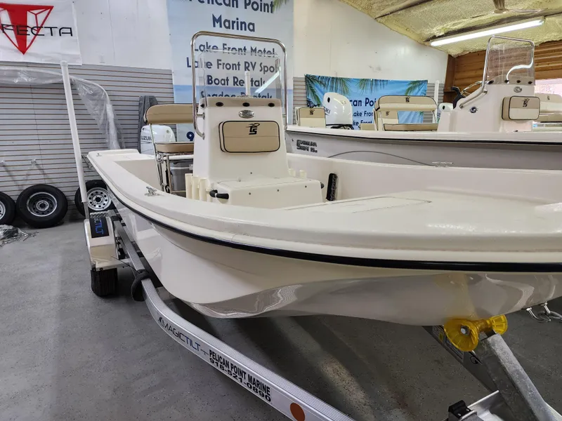 Slide: The Image of 2024 Carolina Skiff E18 JVX CC boat on display in a showroom. - 13