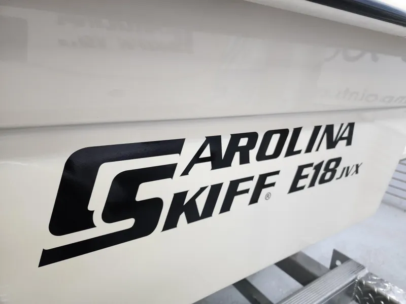 Slide: The Image of 2024 Carolina Skiff E18 JVX CC boat model logo on hull. - 5