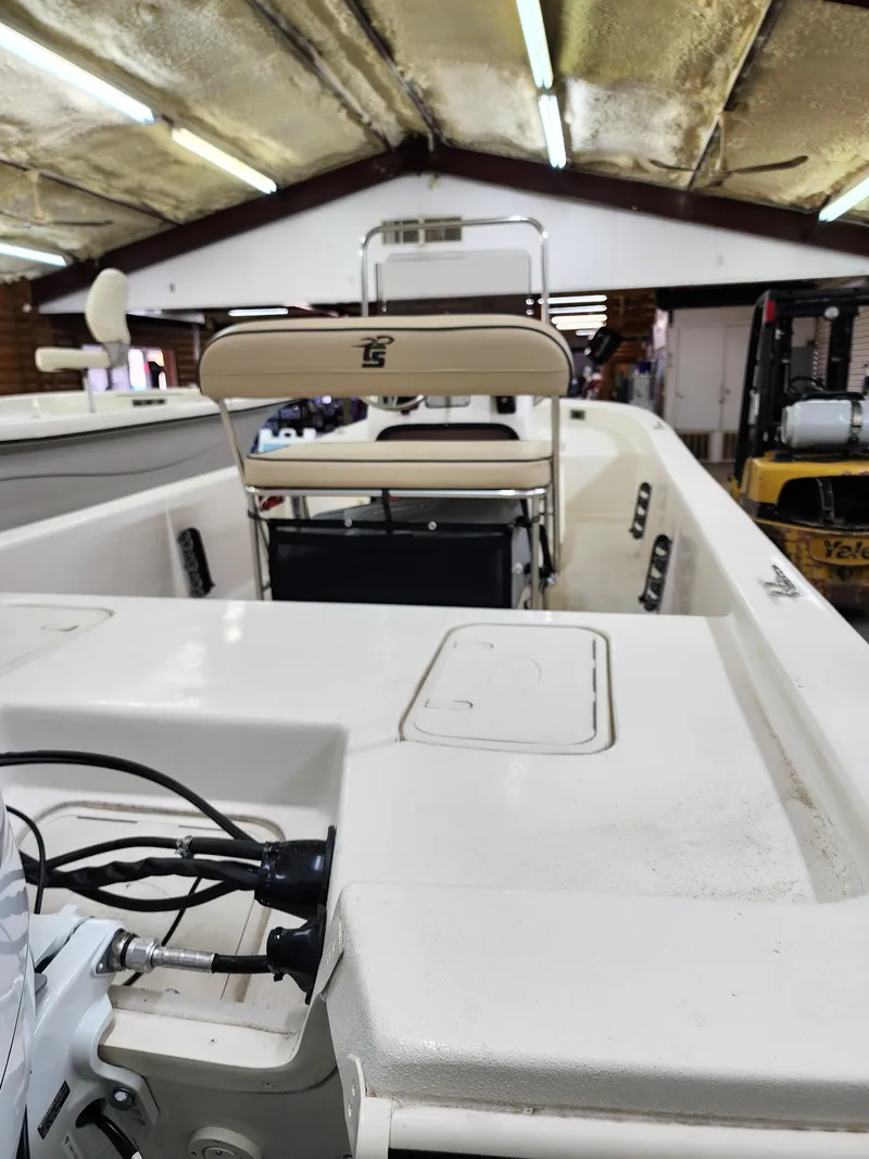 Slide: The Image of 2024 Carolina Skiff E18 JVX CC boat interior in a warehouse. - 8