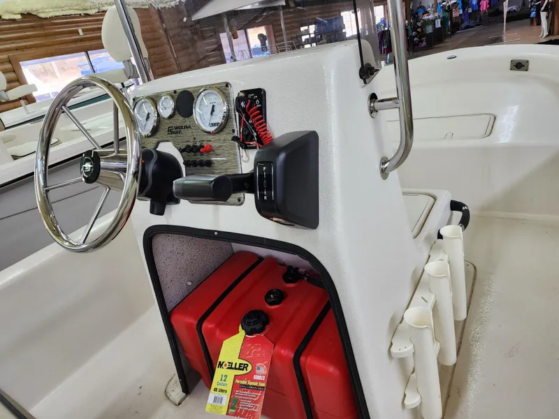 Slide: The Image of 2024 Carolina Skiff E18 JVX CC center console with steering wheel and gauges. - 9