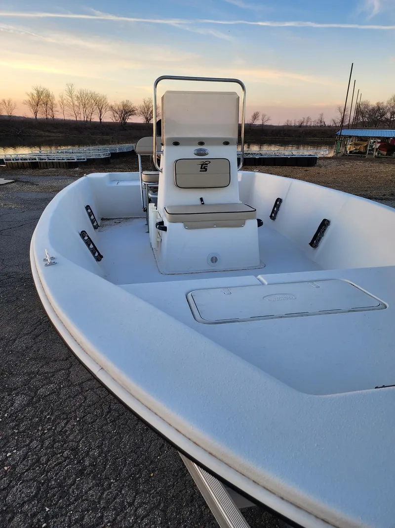 Slide: The Image of 2024 Carolina Skiff EV180 Sea Skiff boat on a trailer at sunset. - 10