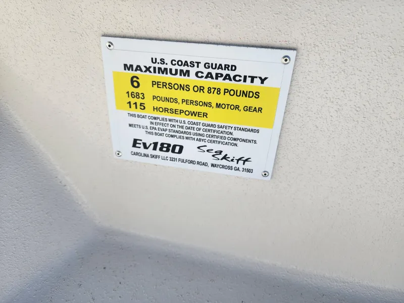 Slide: The Image of 2024 Carolina Skiff EV180 Sea Skiff U.S. Coast Guard capacity label, 6 persons or 878 pounds, 115 horsepower - 15