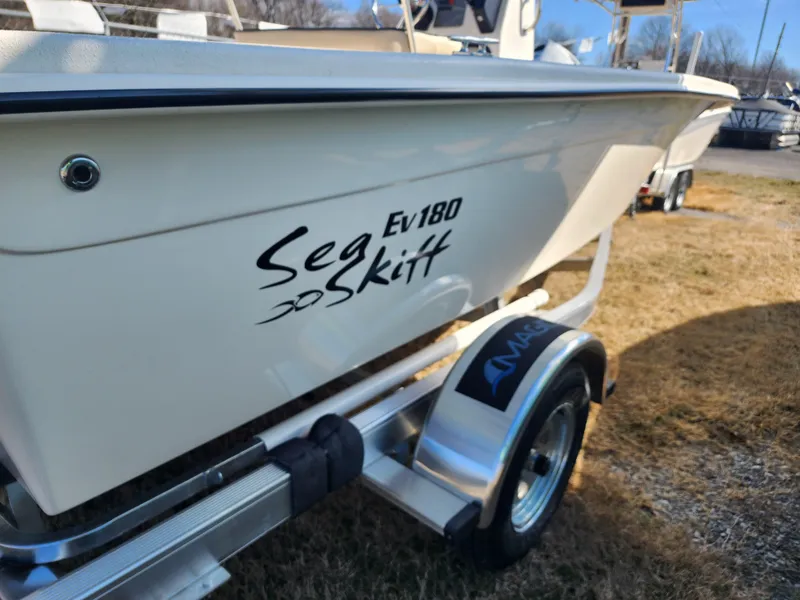 Slide: The Image of 2024 Carolina Skiff EV180 Sea Skiff on trailer, side view. - 2