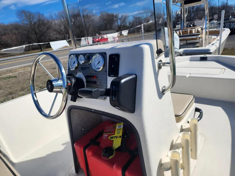 Slide: The Image of 2024 Carolina Skiff EV180 Sea Skiff console with steering wheel and gauges. - 5
