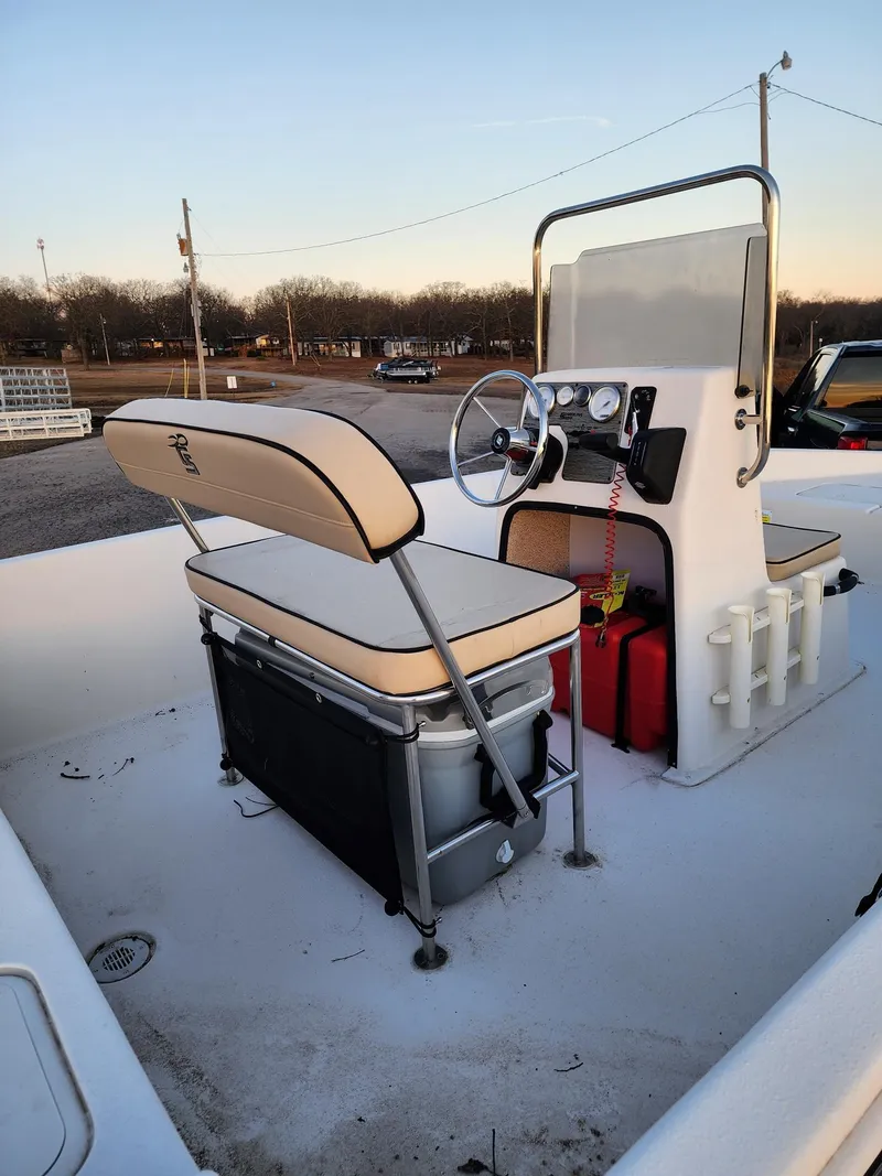 Slide: The Image of 2024 Carolina Skiff EV180 Sea Skiff boat interior with seating and steering console. - 7