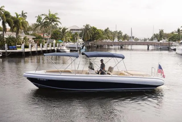 Slide: The Image of 2007 Novurania Chase boat with blue canopy cruising on a calm waterway. - 0