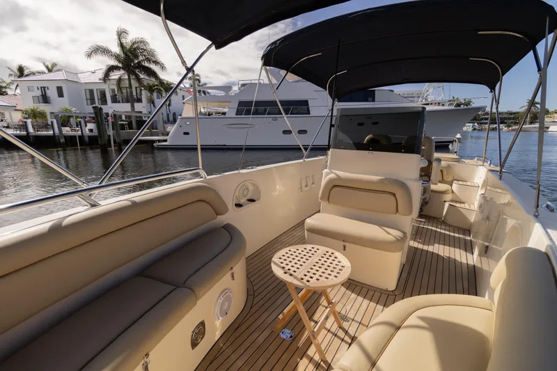 Slide: The Image of 2007 Novurania Chase boat interior with beige seating, wooden deck, and waterfront view. - 1
