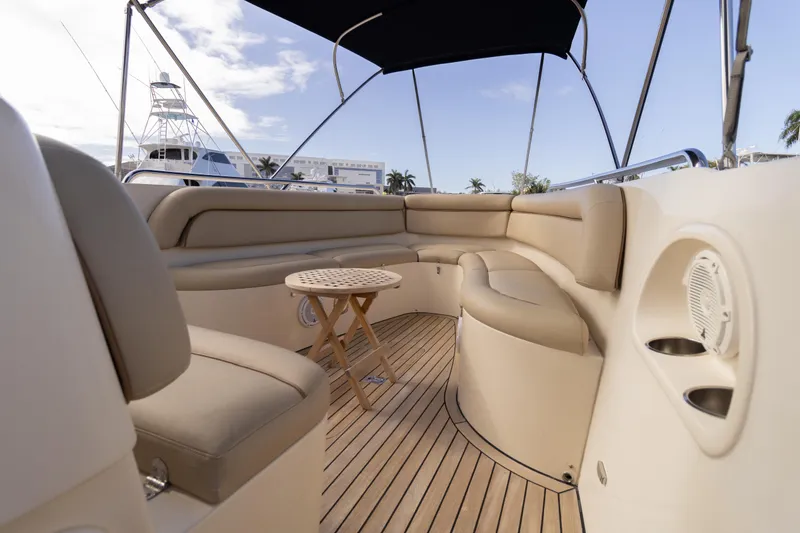 Slide: The Image of 2007 Novurania Chase boat interior with beige seating and wooden deck. - 2