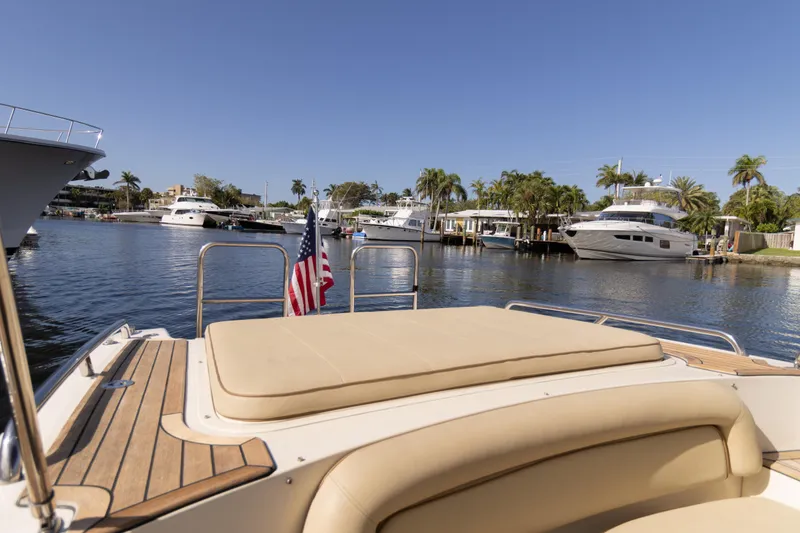 Slide: The Image of 2007 Novurania Chase boat docked in a sunny marina with palm trees and yachts. - 3