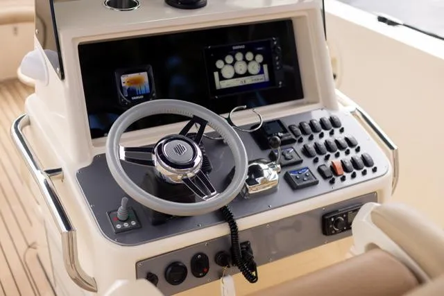 Slide: The Image of Control panel of a 2007 Novurania Chase boat with steering wheel and navigation instruments. - 8