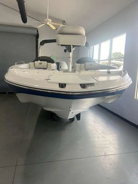 Slide: The Image of 2024 Hurricane 218 SS boat in showroom, front view. - 1