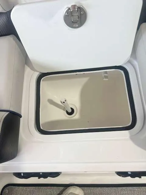 Slide: The Image of 2024 Hurricane 218 SS boat storage compartment with open lid. - 7