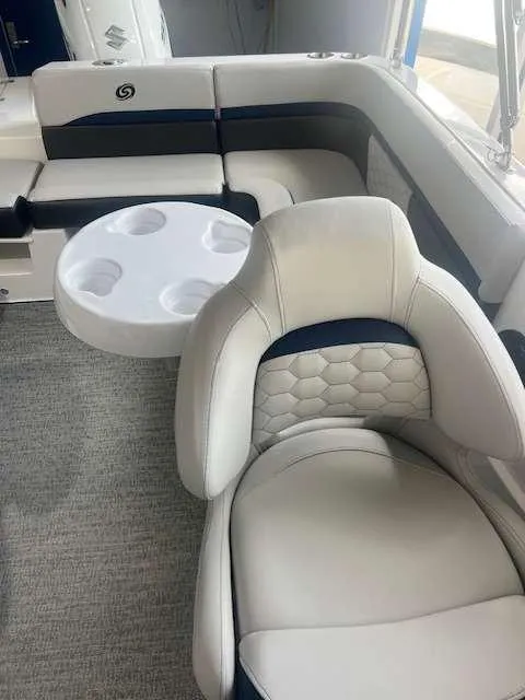 Slide: The Image of 2024 Hurricane 218 SS boat interior with plush seating and cup holders. - 9