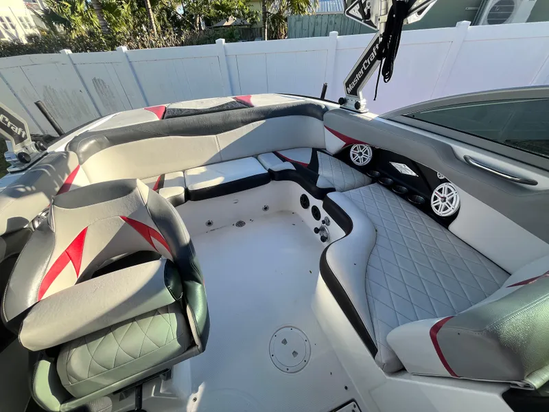 Slide: The Image of 2009 MasterCraft MariStar 230 boat interior with gray and red seating. - 19