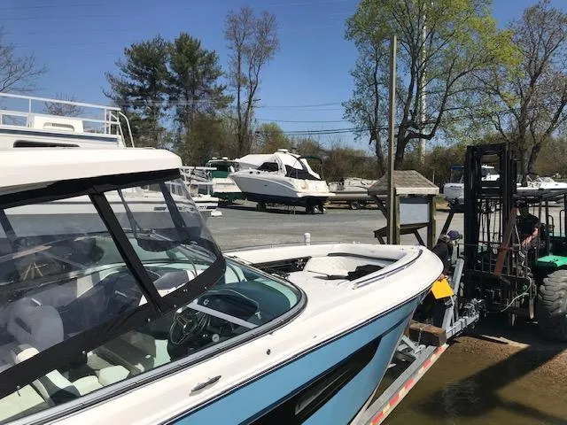 Slide: The Image of 2018 Regal 3300 Bow Rider boat being transported at a marina. - 3