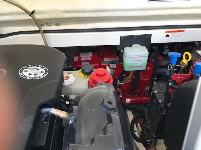 Slide: The Image of Engine compartment of a 2018 Regal 3300 Bow Rider boat, showcasing various components. - 39