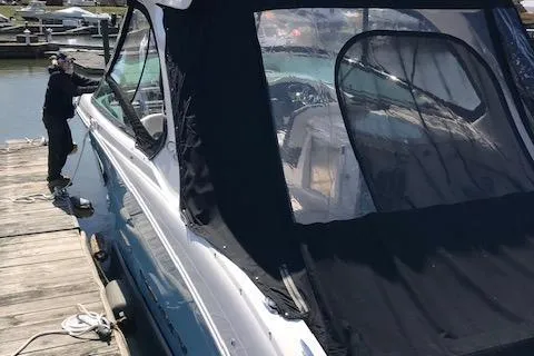 Slide: The Image of 2018 Regal 3300 Bow Rider docked with black canopy cover. - 41