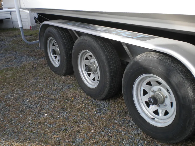 Slide: The Image of Triple-axle trailer for 2018 Regal 3300 Bow Rider boat on gravel. - 43