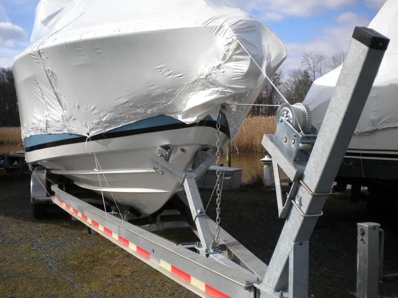 Slide: The Image of 2018 Regal 3300 Bow Rider boat covered on a trailer, ready for transport. - 44