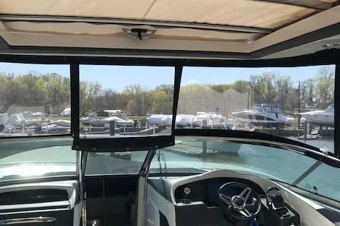 Slide: The Image of 2018 Regal 3300 Bow Rider interior view with marina backdrop. - 5