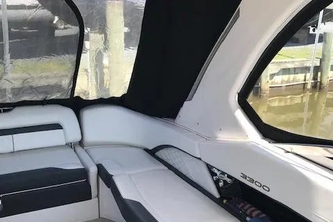 Slide: The Image of 2018 Regal 3300 Bow Rider interior with white seating and black accents. - 7