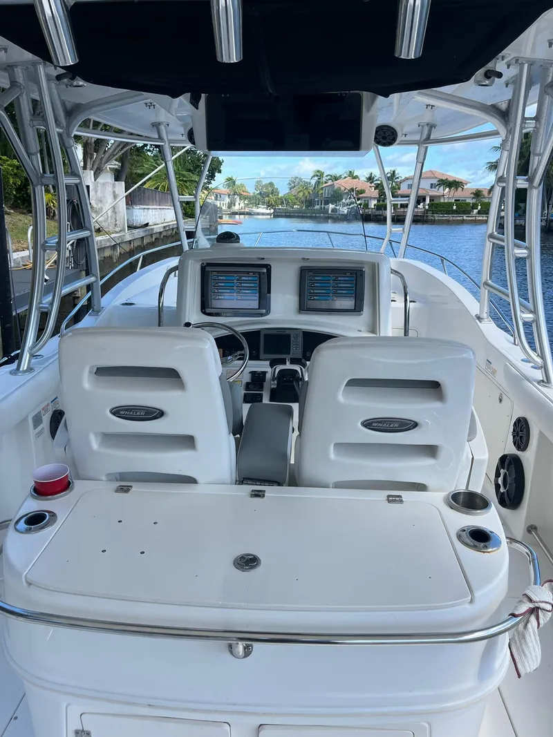 Slide: The Image of 2006 Boston Whaler 320 Outrage Cuddy Cabin boat interior with dual screens and seating. - 10
