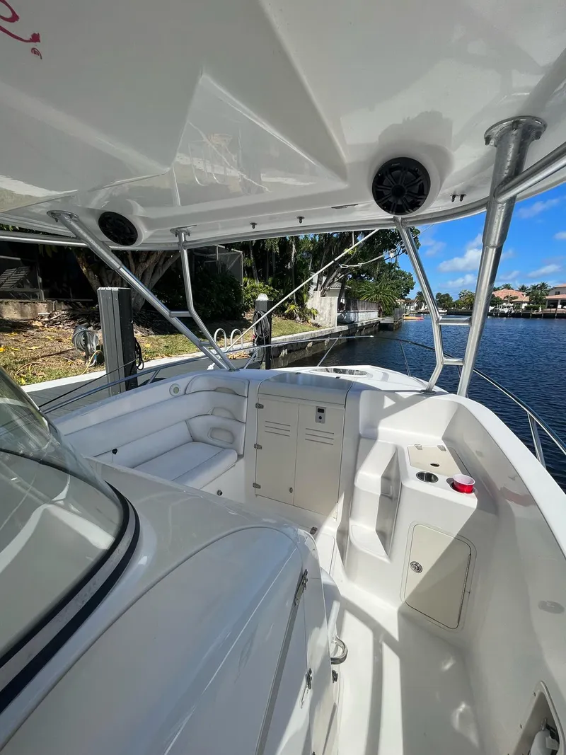 Slide: The Image of 2006 Boston Whaler 320 Outrage Cuddy Cabin boat interior by the water. - 16