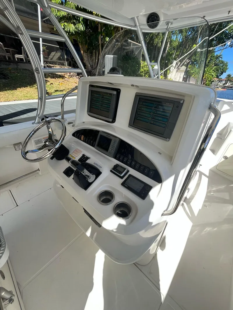 Slide: The Image of 2006 Boston Whaler 320 Outrage Cuddy Cabin helm with dual displays and controls. - 5