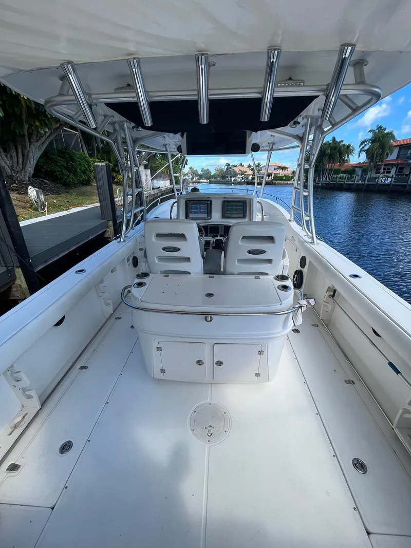 Slide: The Image of 2006 Boston Whaler 320 Outrage Cuddy Cabin boat interior, featuring helm and seating area. - 9