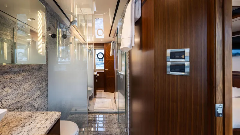 Slide: The Image of Luxurious bathroom interior of 2018 Ocean Alexander 85 E yacht, featuring elegant wood and marble finishes. - 13