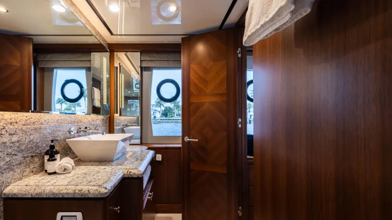 Slide: The Image of Luxurious bathroom in 2018 Ocean Alexander 85 E yacht with elegant wood and granite finishes. - 14