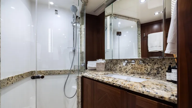 Slide: The Image of Luxurious bathroom in 2018 Ocean Alexander 85 E yacht with granite countertops and glass shower. - 22