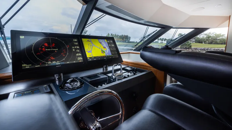 Slide: The Image of Pilothouse of 2018 Ocean Alexander 85 E yacht with navigation screens and steering wheel. - 44